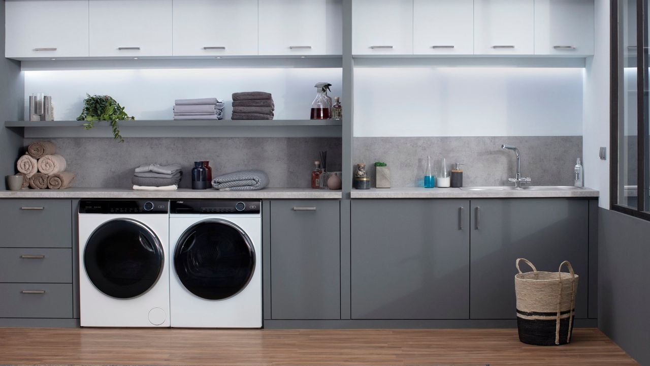 the Haier washer dryer, one of the best washing machine options, in a modern grey and white kitchen