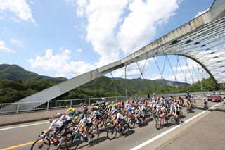 The peloton rides across a bridge during the womens cycling road race of the Tokyo 2020 Olympic Games finishing at the Fuji International Speedway in Oyama Japan on July 25 2021 Photo by MICHAEL STEELE POOL AFP Photo by MICHAEL STEELEPOOLAFP via Getty Images