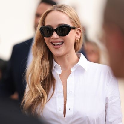 Jennifer Lawrence in a white button-down shirt.