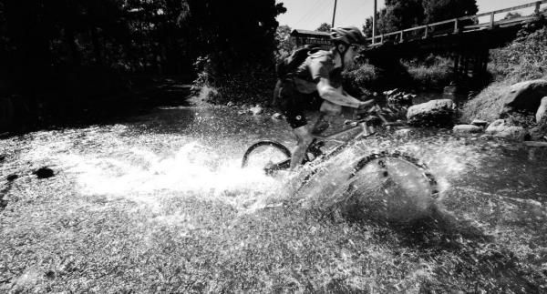 A rider cross a stream