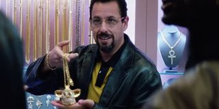 Uncut Gems Adam Sandler shows off a golden Furby