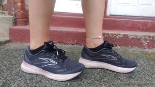 Brooks Glycerin 19 trainers being worn by person standing in doorway
