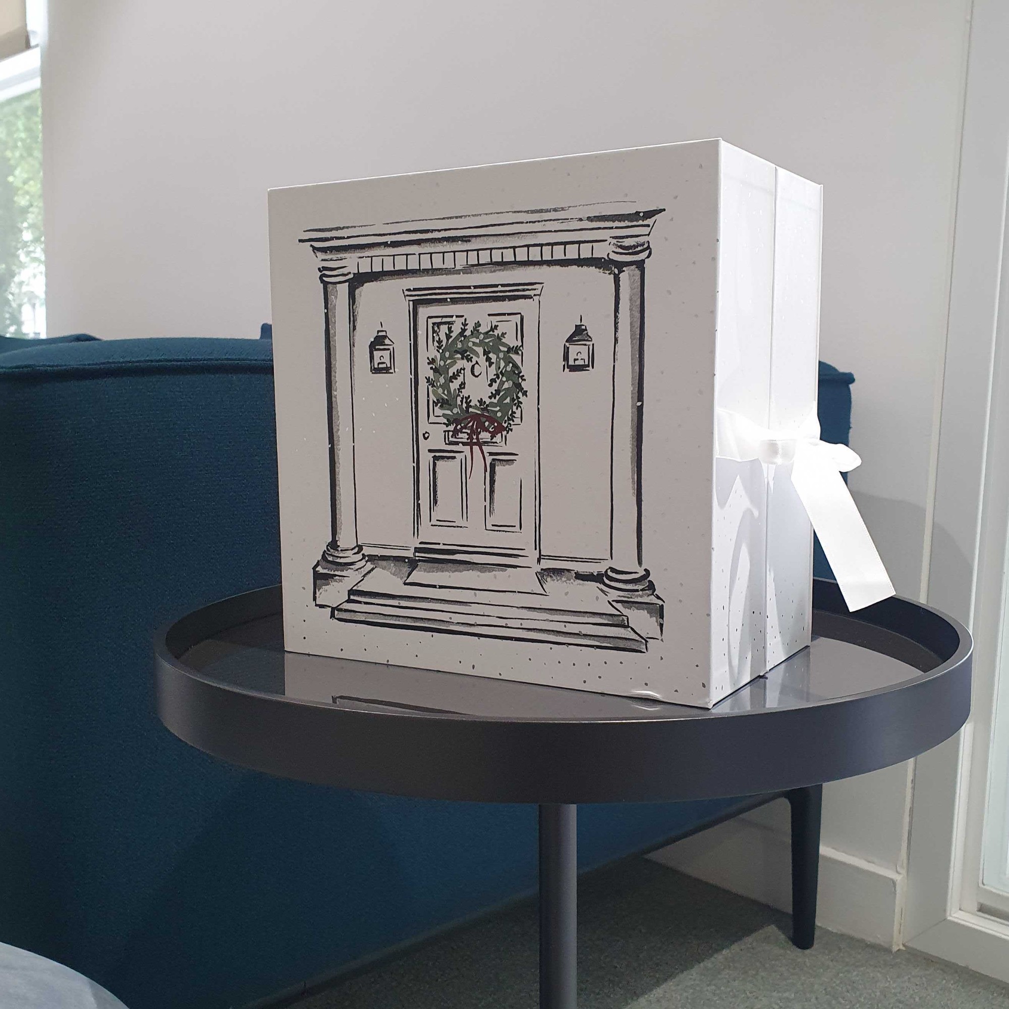 The White Company 12 Days Of Fragrance Advent Calendar closed on a side table