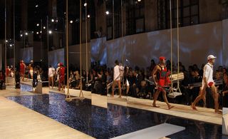 Models on runway with water