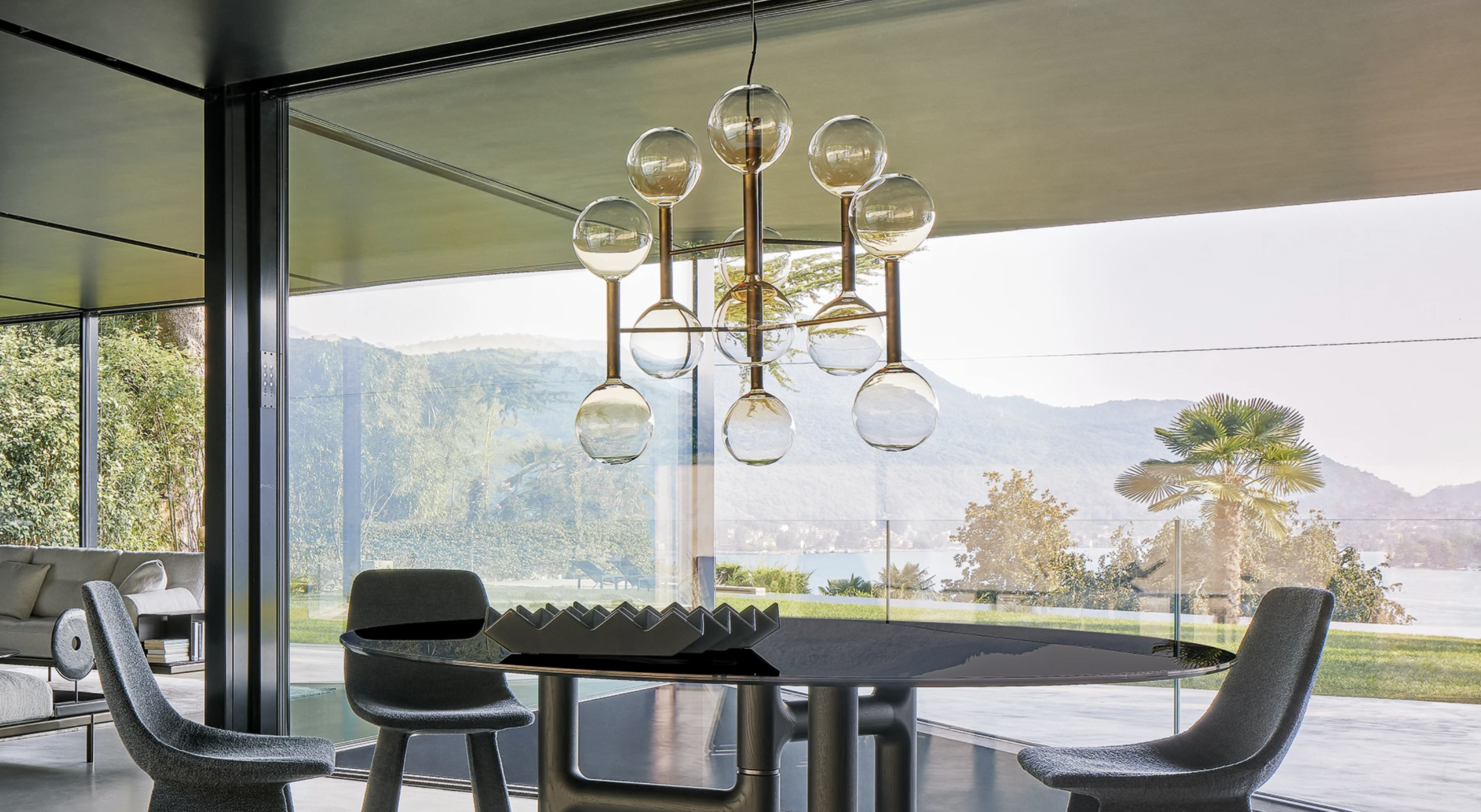 a large glass chandelier over a dining table in a contemporary home