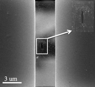 An electron microscope image shows a pre-crack in a suspended sheet of graphene used to measure the overall strength of the sheet in a test at Rice University.