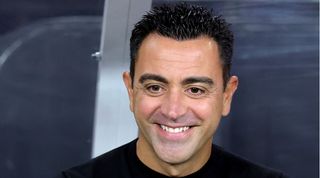 Xavi smiles ahead of a Barcelona friendly match against Real Madrid in 2022.