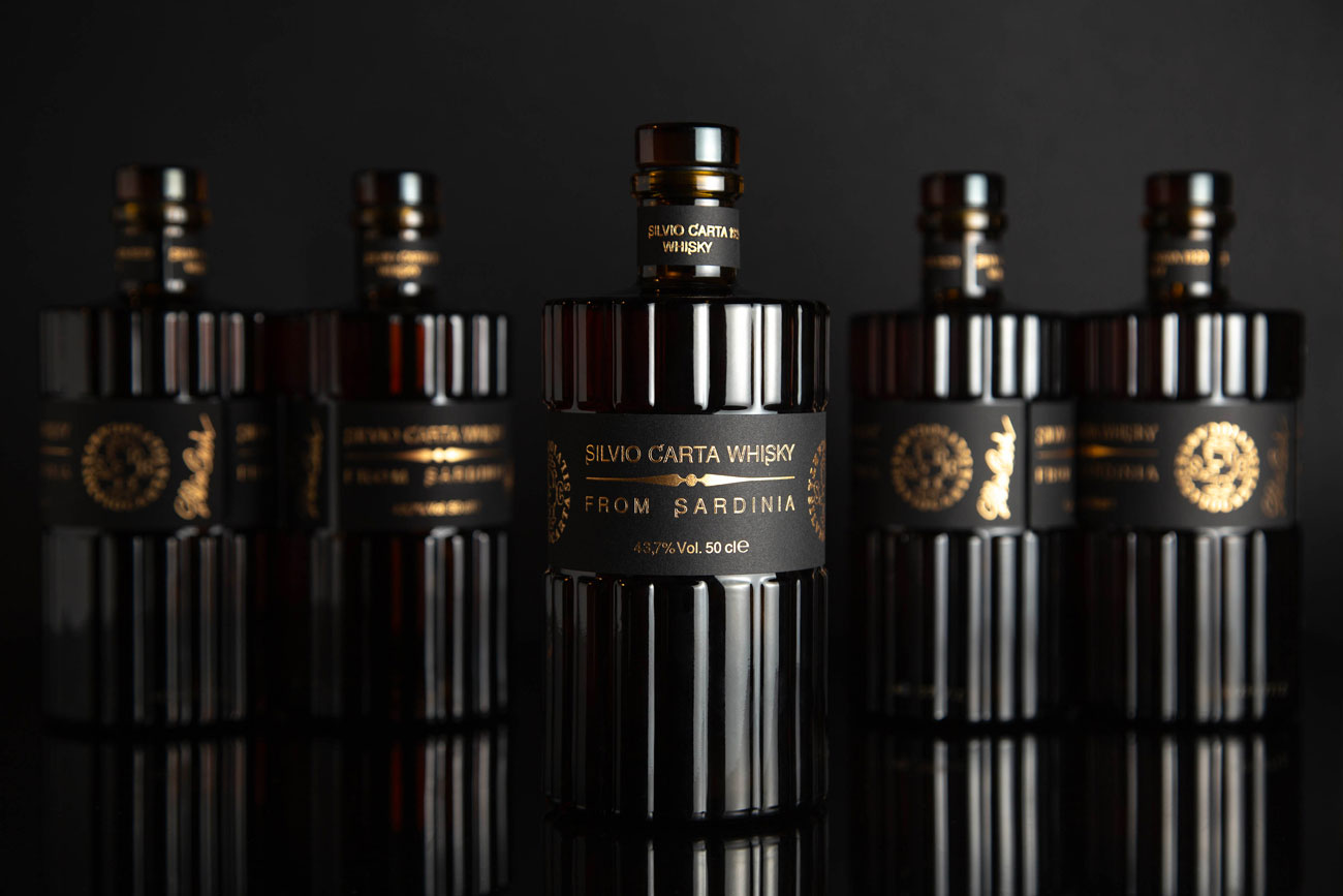 Line up of Silvio Carta whisky bottles
