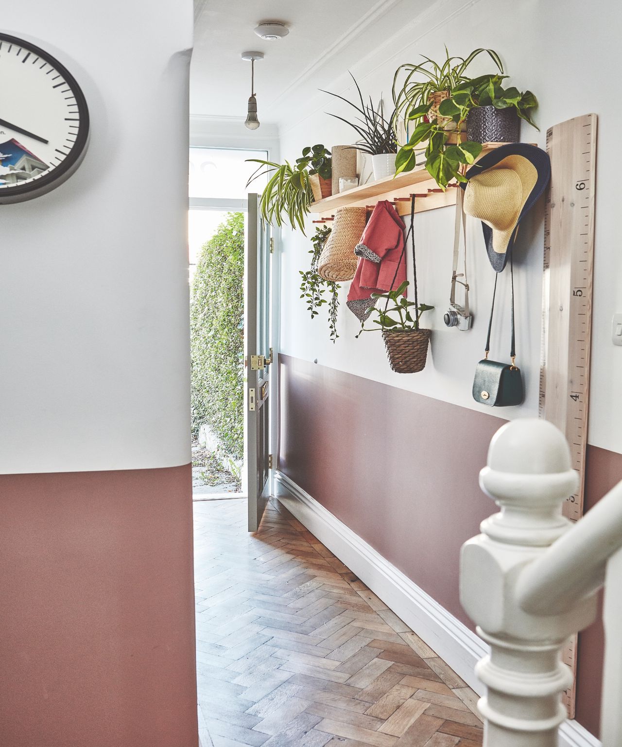 Entryway with painted mole colored walls and white stair banister
