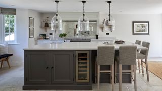 large kitchen island with seating area, storage and glass pendant lighting above