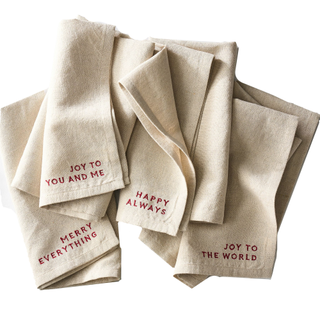 A set of 4 embroidered Christmas napkins with joyful phrases