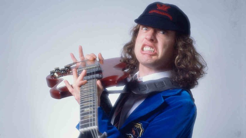 AC/DC’s Angus Young holding a guitar