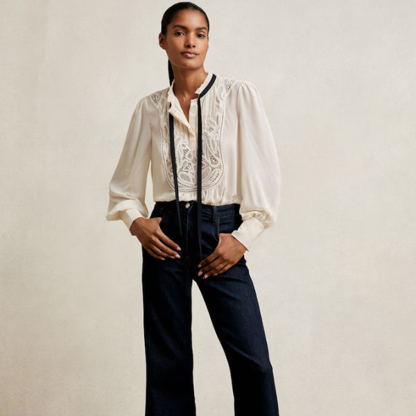 A model wearing a cream top and jeans