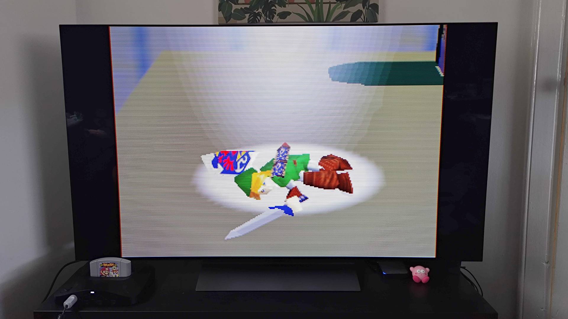 Analogue 3D connected to LG OLED TV with Super Smash Bros intro on screen featuring Link lying in spotlight.