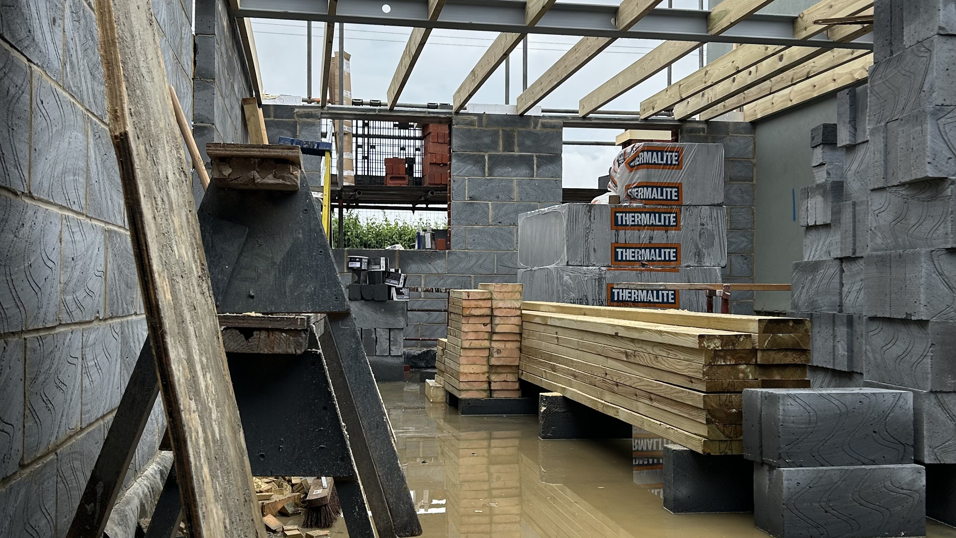 Building site with breeze block extension walls and concrete floors 