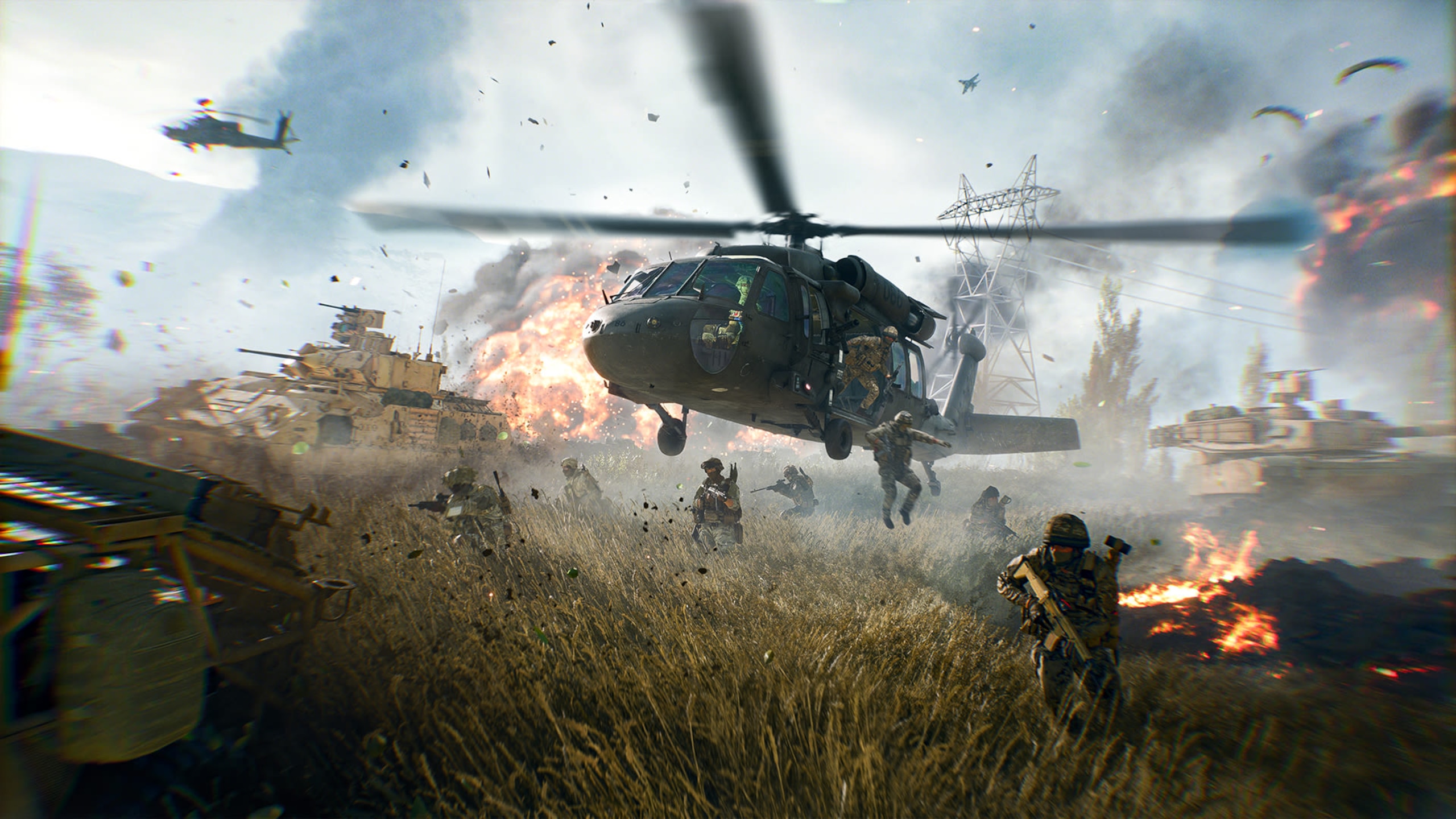 A helicopter lands amongst the heat of battle