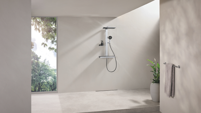 a modern industrial shower room with lots of natural light and the GROHE rain shower