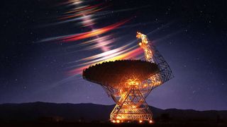 a beam is being emitted from a large satellite dish pointed up toward the night sky.