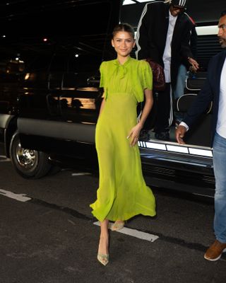 Zendaya wears a chartreuse chiffon dress with coordinating shoes in New York City to promote Challengers