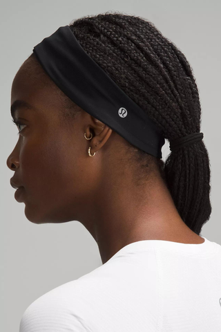 side profile of a woman wearing a black Lululemon headband