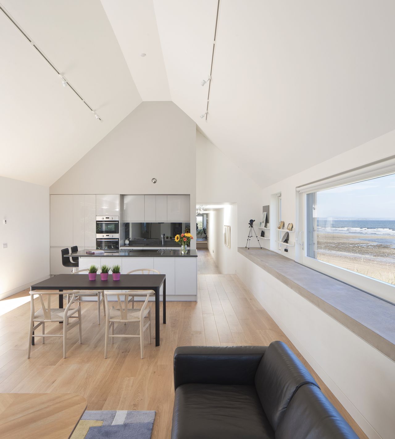 open plan kitchen and living area with vaulted ceiling