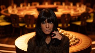 Claudia Winkleman poses in front of the Round Table for The Traitors season 2