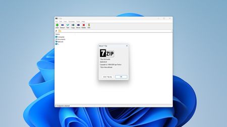 A screenshot of 7-Zip with its About window open, showing version 26.02 which fixes a vulnerability.