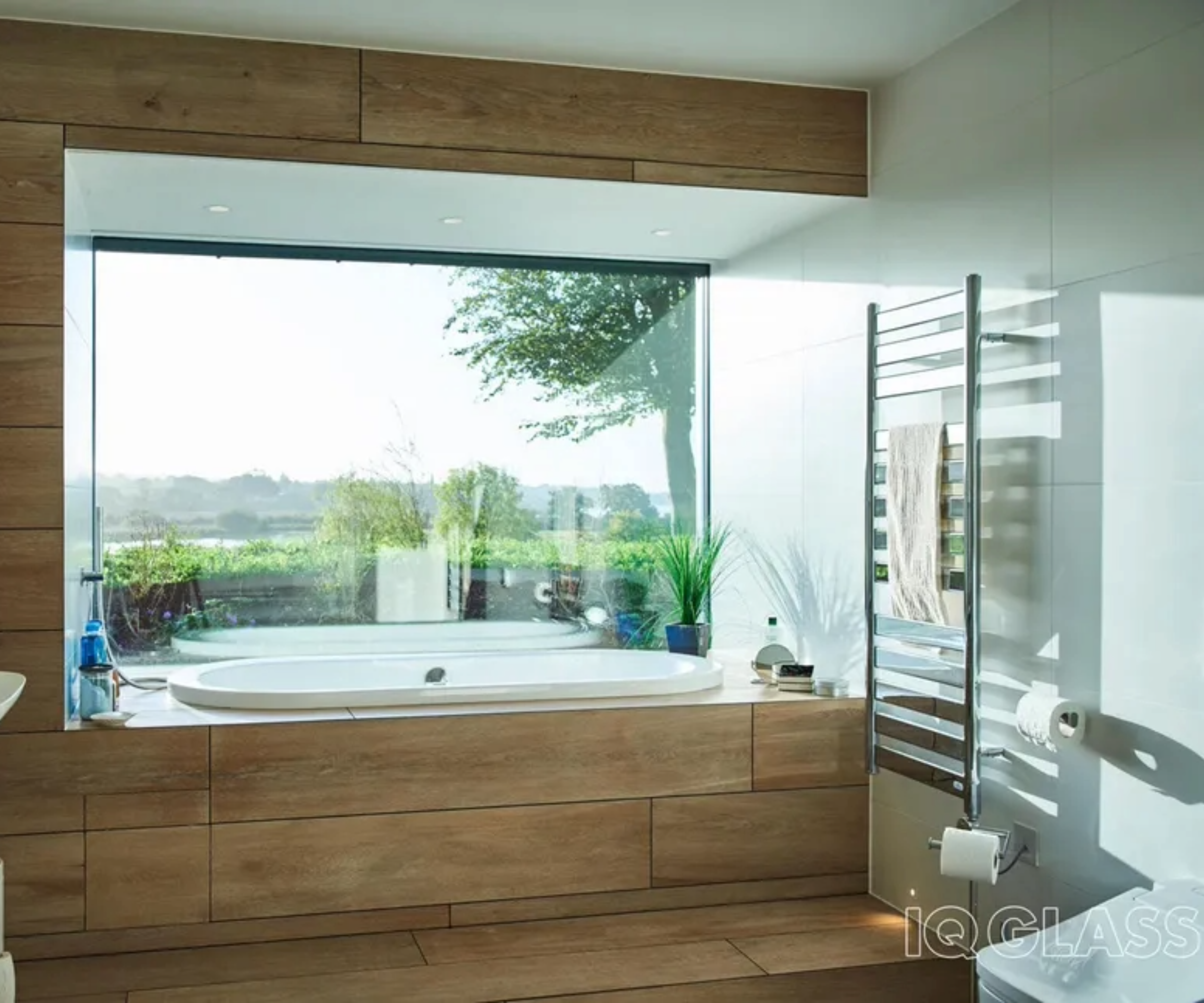 a bathroom with a bath in front of a picture window