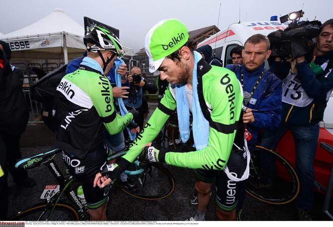 Belkin teammates getting warm clothing on after the stage 8 race in the rain