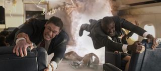 President Derringer and Prime Minister Clark holding onto seats after hole exploded in Air Force One in Heads of State