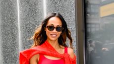 Zoe Saldaña in red top and tortoiseshell sunglasses