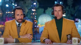 Joe Tessitore and Rob Riggle sitting at their desk in Holey Moley.