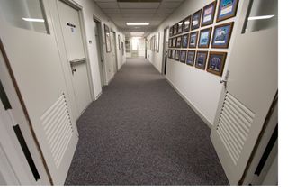 A hallway inside the astronaut quarters sports new carpeting and a fresh coat of paint.
