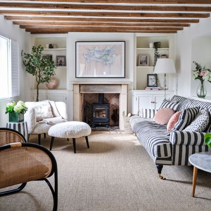 Period living room with carpet and a selection of striped sofas and accent chairs