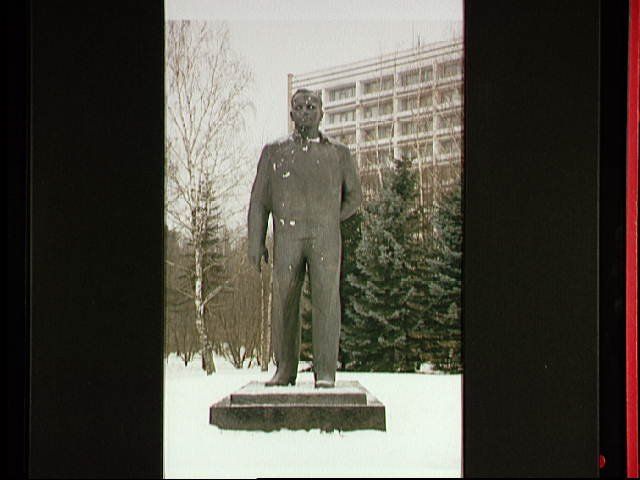 A monument in honor of cosmonaut Yuriy A. Gagarin, the first human to fly in space, stands in front of a cosmonaut apartment building at the Gagarin Cosmonaut Training Center in Star City, Russia.
