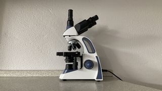 Swift SW380T microscope side view against a white wall
