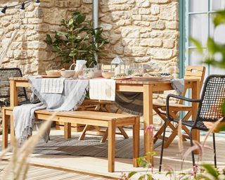 outdoor wooden table and bench on decking from B&Q