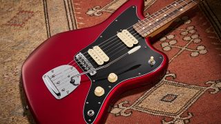 A Fender Player Jazzmaster lying on a rug.