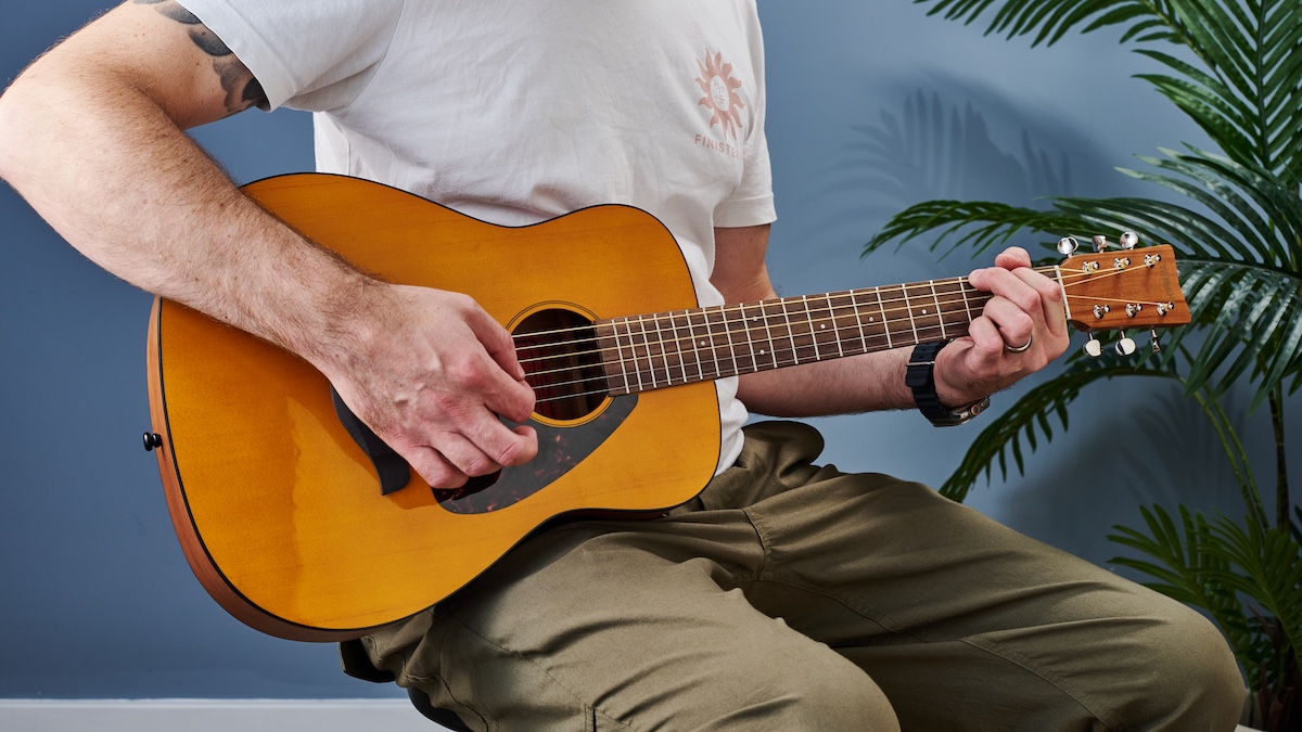 Man playing a Yamaha JR1 acoustic guitar
