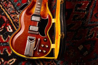 A Certified Vintage Gibson 1961 Les Paul SG Standard guitar sits in its case