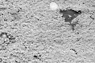 The micro-structure of the albite sample after compression to 46 gigapascals (GPa) at a rate of 35 GPa per second. This image shows a section 0.007 millimeters across.