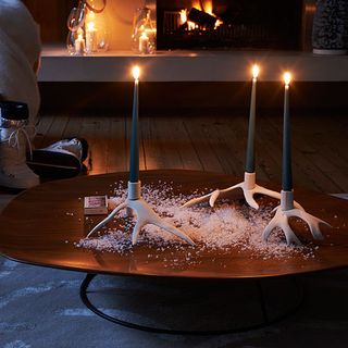 coffee table with candlestick and fake snow