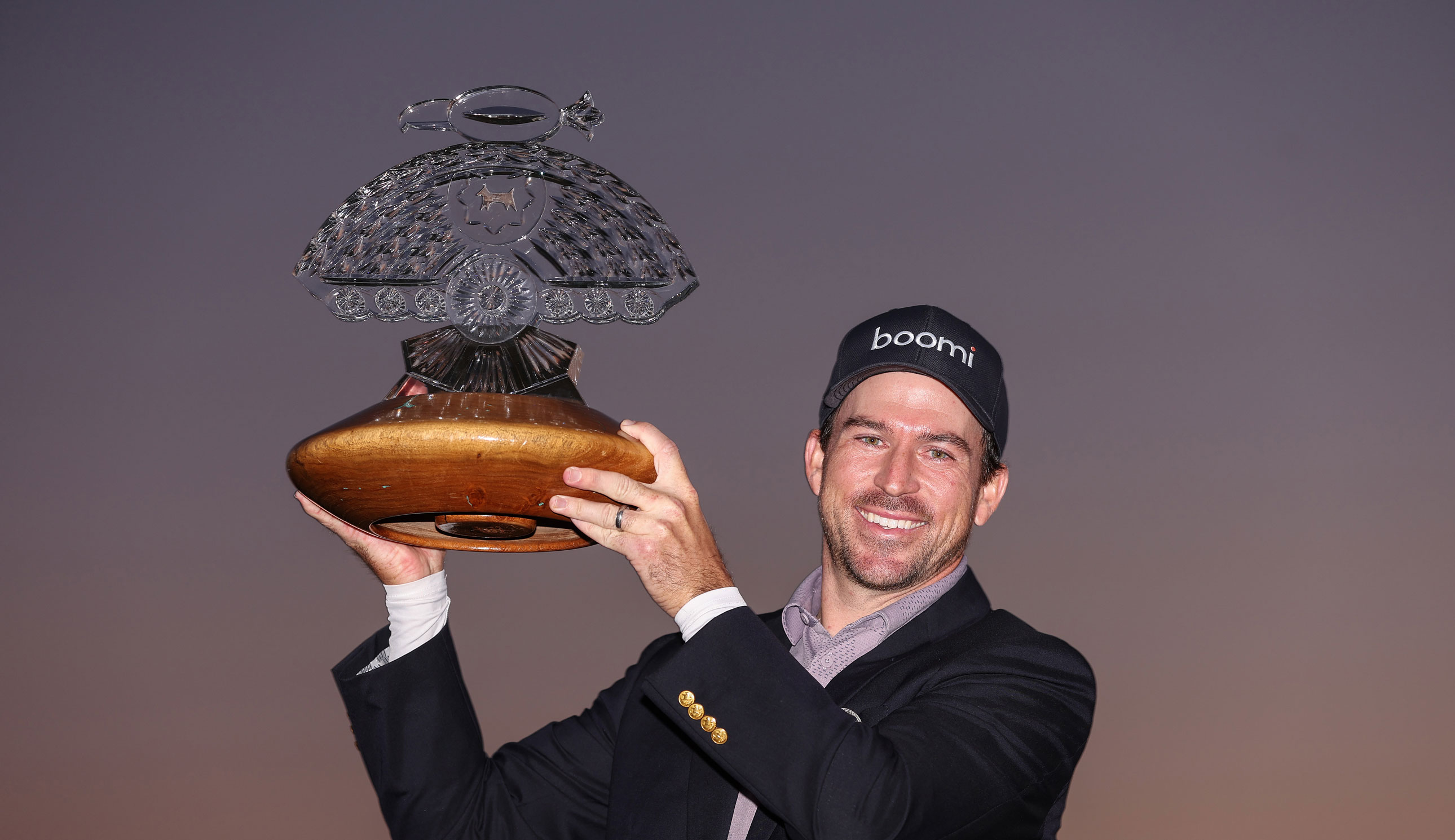 Nick Taylor holds the WM Phoenix Open in the air