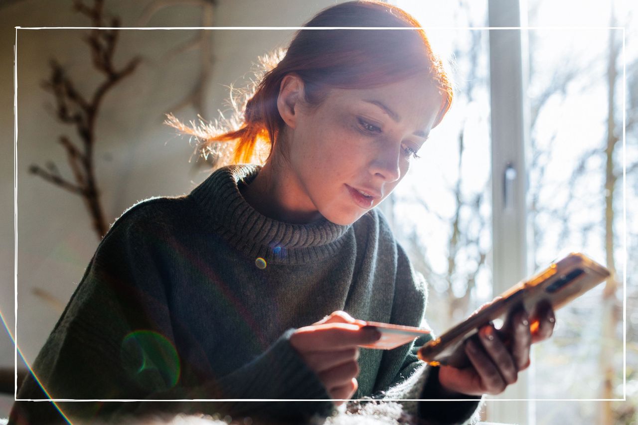 woman using credit card to shop online using her phone