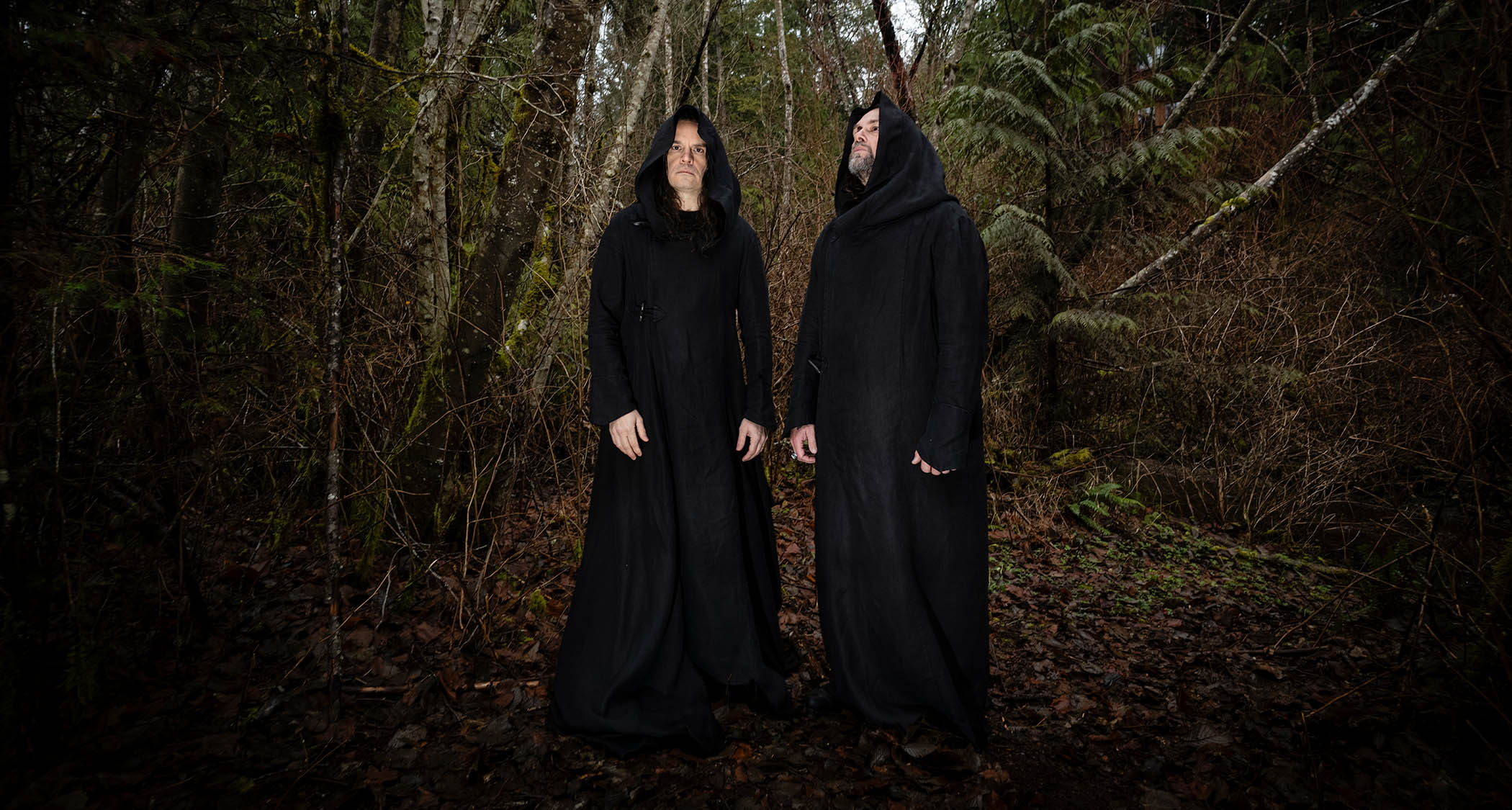 Stephen O'Malley [left] and Greg Anderson of Sunn O))) are photographed in a forest