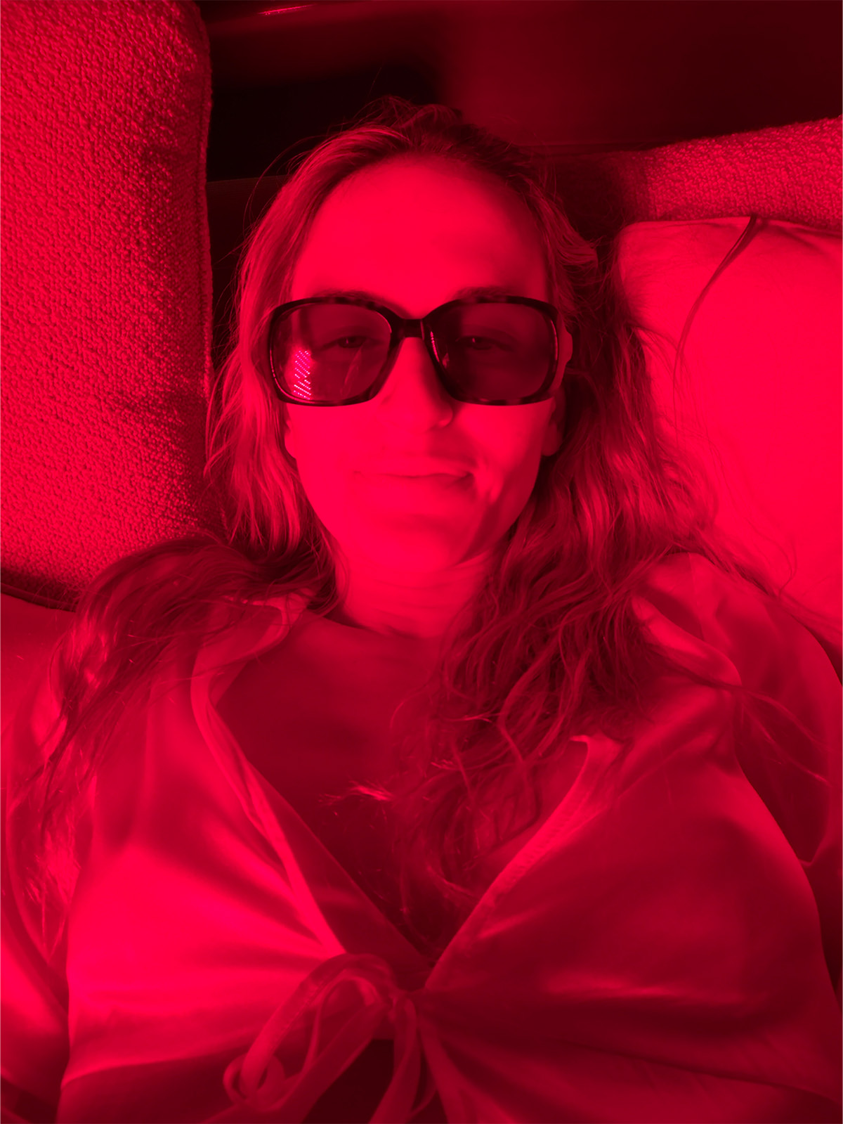 Eliza Huber using a red light panel.