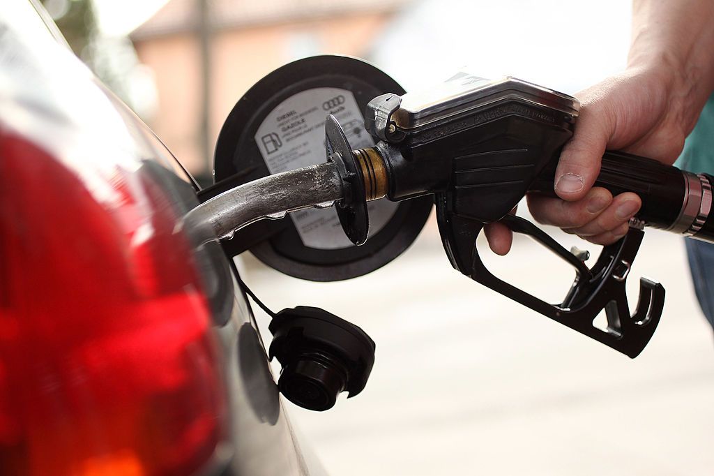 Station attendant pumping gas.