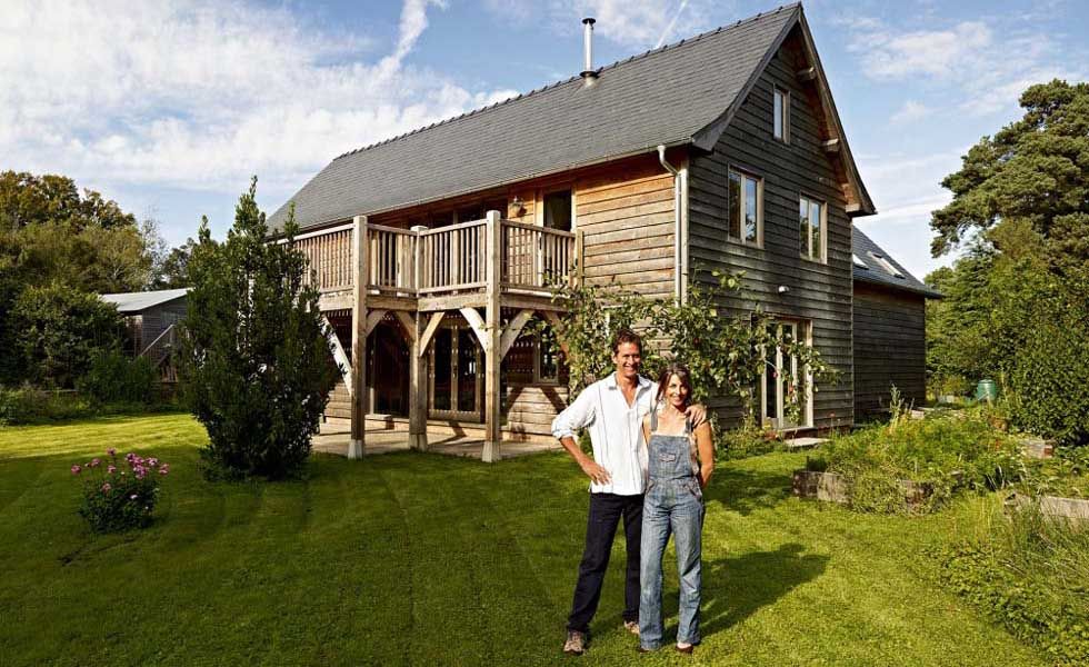 Couple outside an oak frame self build