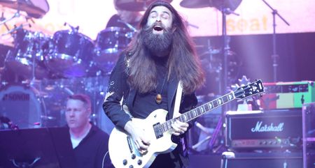 Crown Lands' Kevin Comeau performs live with a white Yamaha SG