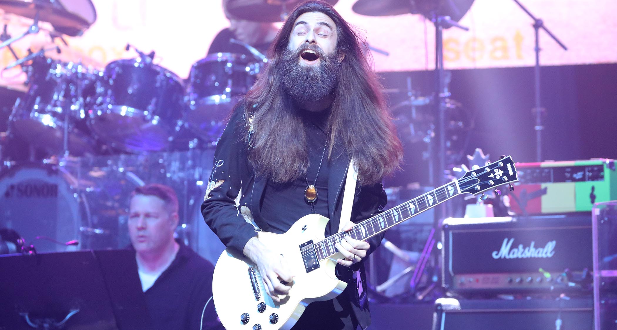 Crown Lands' Kevin Comeau performs live with a white Yamaha SG